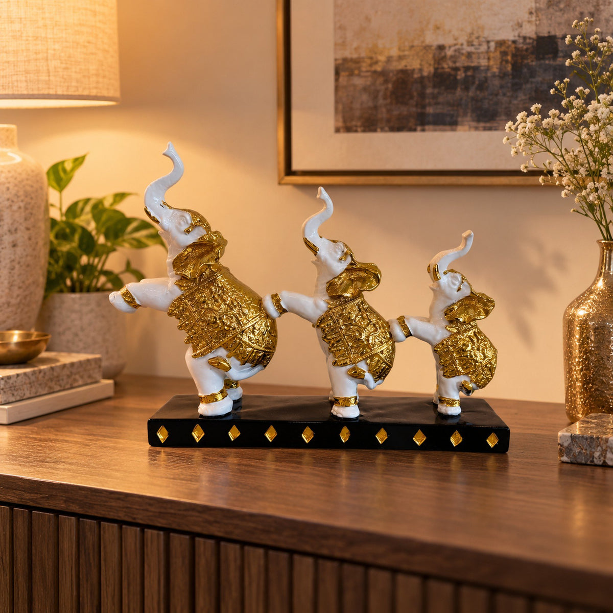 3-Piece Dancing Elephant Figurine - Gold and White displayed in a home setting