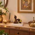 Baby Krishna Brown Figurine with Butter Pot displayed in a home setting