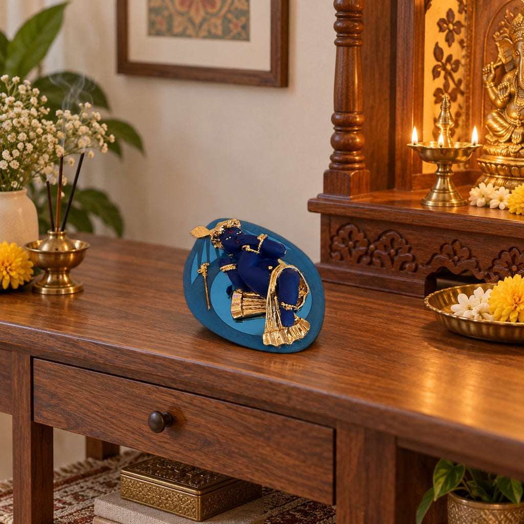 Blue and Gold Baby Krishna Figurine on Leaf Base displayed in a home setting