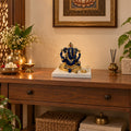 Blue and Gold Ganesh Idol on Marble-Look Base displayed in a home setting